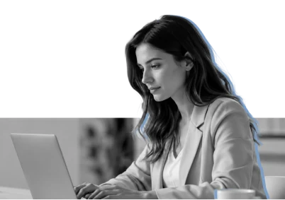 An expert working at a laptop in a bright office