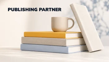 Publishing Partner — a stack of books with a mug and an upright volume leaning against them