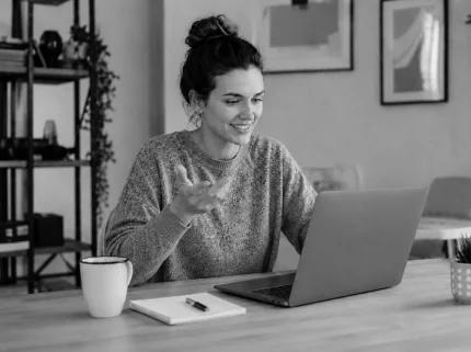 An author talking through her book on a video call at her laptop